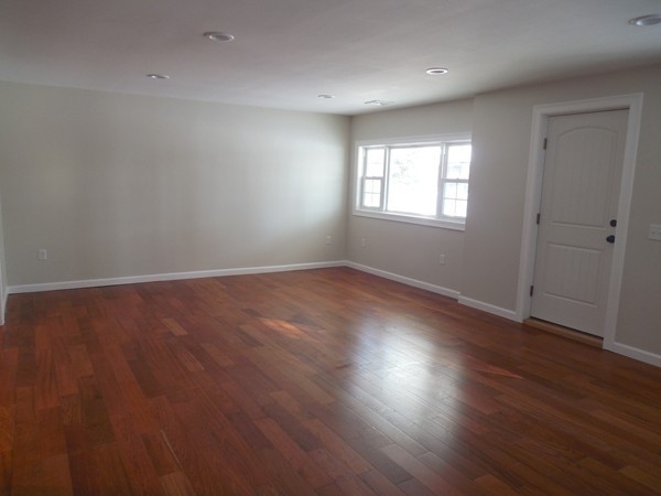 13 Pierceville Road Wareham, MA 02576 - Photo 4 of 9 an empty room with wooden floor and windows