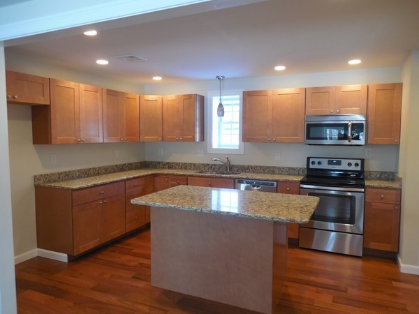 13 Pierceville Road Wareham, MA 02576 - Photo 5 of 9 a kitchen with stainless steel appliances granite countertop a stove a sink and a microwave