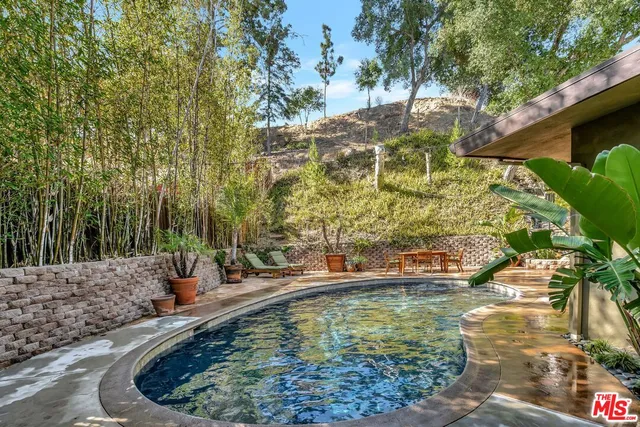 a view of house with backyard outdoor seating and patio
