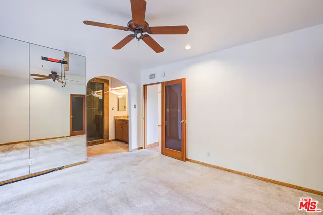 a bathroom with a granite countertop sink a mirror and a bathtub