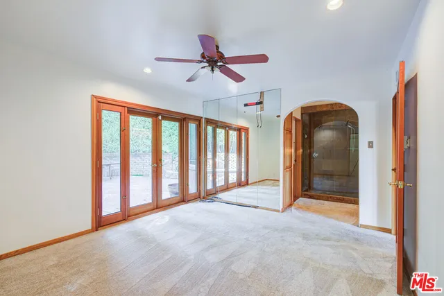 a bathroom with a granite countertop sink mirror vanity and toilet