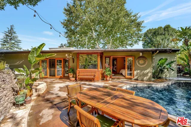 a balcony with wooden floor and outdoor seating
