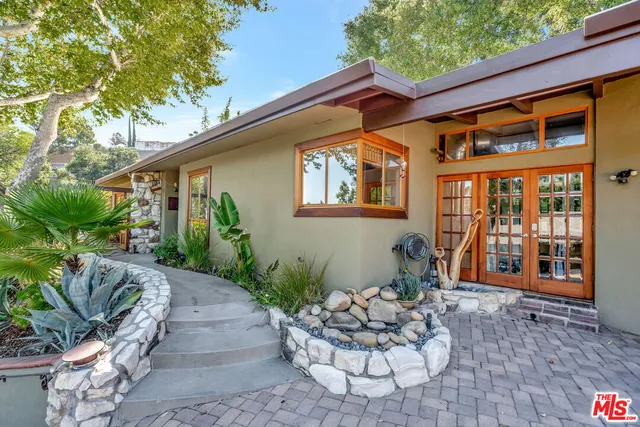 a room that has a large window and furniture