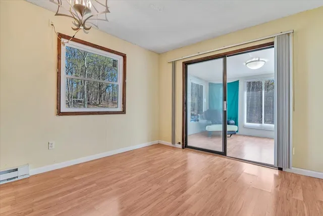 a view of an empty room with glass door