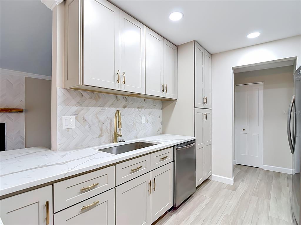4536 Mitcher Road New Port Richey, FL 34652 - Photo 38 of 46 a kitchen with granite countertop a sink and cabinets