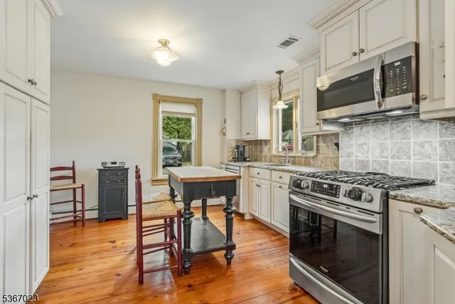 a kitchen with stainless steel appliances a stove a sink and a microwave