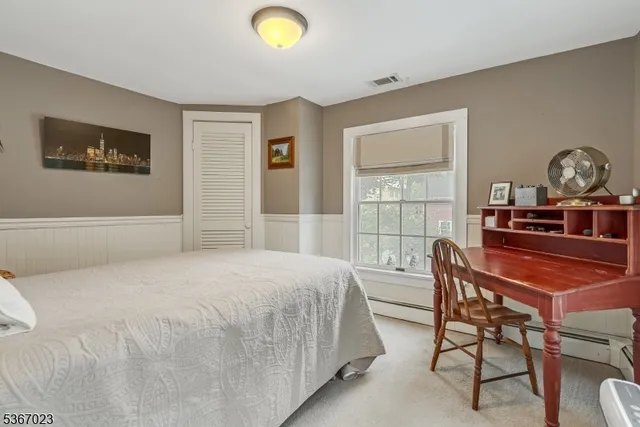 a bedroom with a bed and a table in it