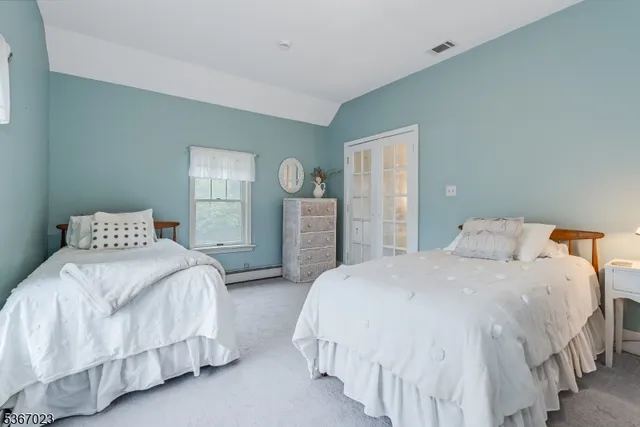 a bedroom with bed and wooden floor