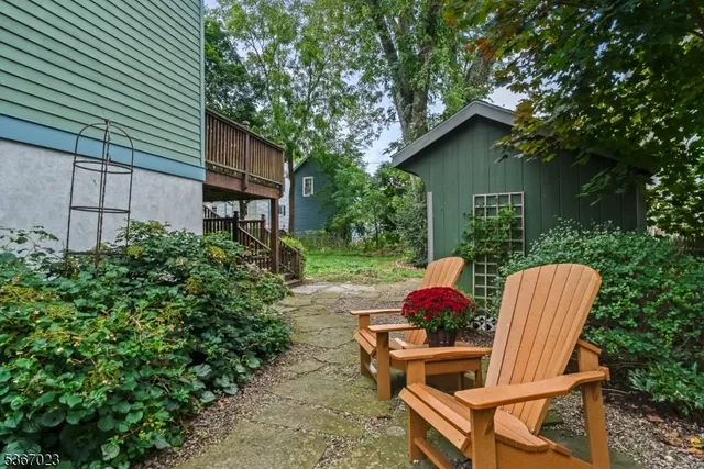 a view of backyard with table and chairs and potted plants
