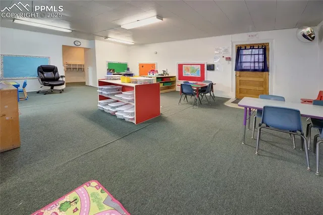a living room with furniture and a work place