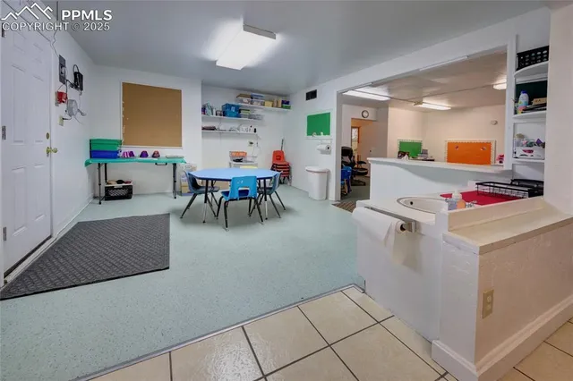 a living room with furniture and a dining table with kitchen view