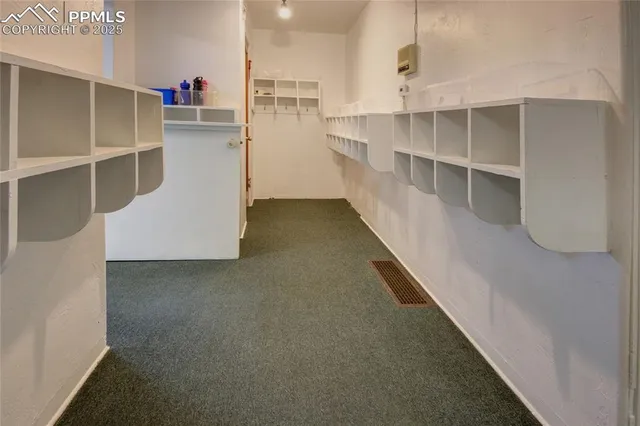 a view of a living room with cabinets