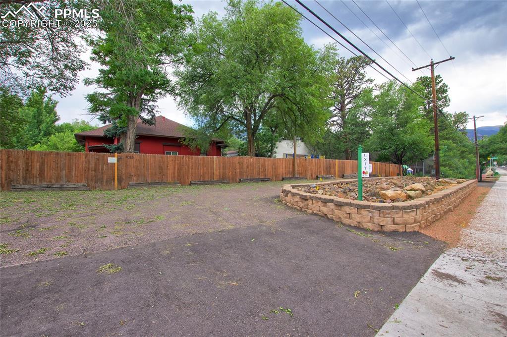 1015 West Cheyenne Road Colorado Springs, CO 80906 - Photo 23 of 33 a view of a backyard with large trees and wooden fence