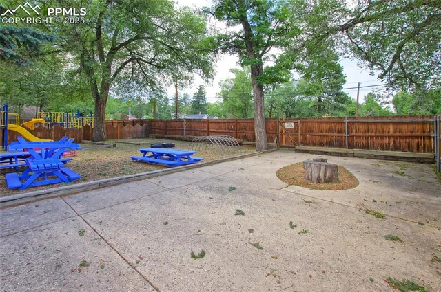 a backyard of a house with table and chairs