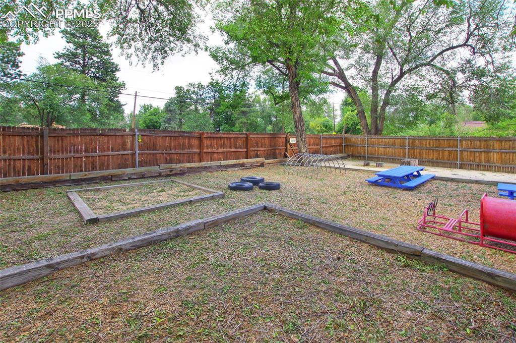 1015 West Cheyenne Road Colorado Springs, CO 80906 - Photo 27 of 33 a view of a backyard with wooden fence and a large tree