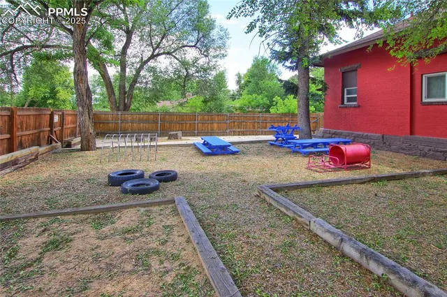 a view of a backyard with chairs and a fire pit