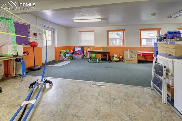 a view of a room with gym equipment and a large window