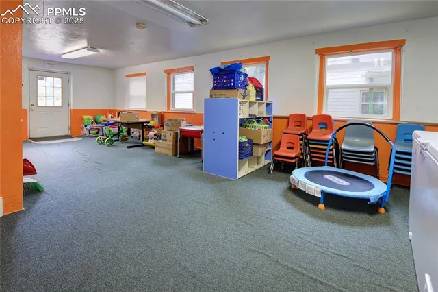 a bedroom with furniture and a large window