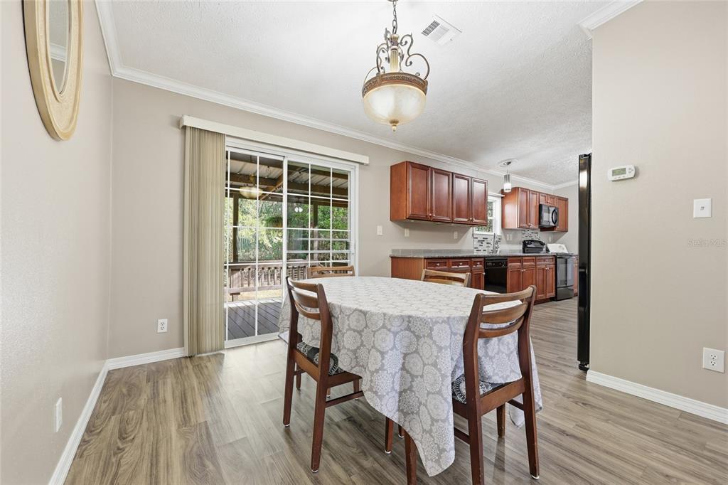269 Southwest Backwoods Glen Fort White, FL 32038 - Photo 13 of 31 a view of a dining room with furniture window and wooden floor