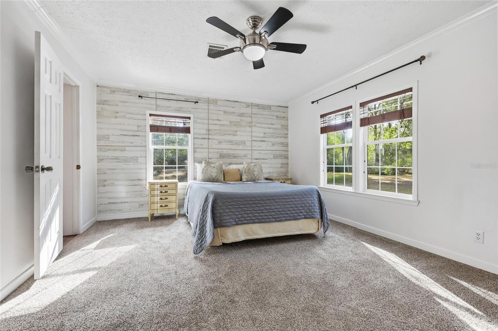 269 Southwest Backwoods Glen Fort White, FL 32038 - Photo 14 of 31 a spacious bedroom with a bed and a large window