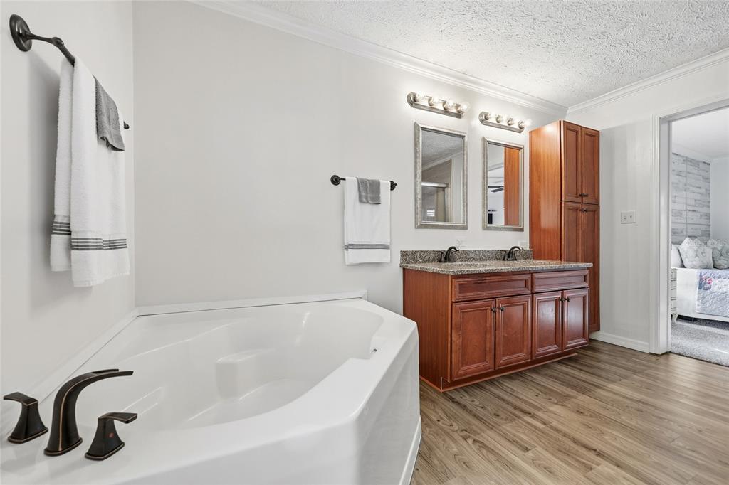 269 Southwest Backwoods Glen Fort White, FL 32038 - Photo 17 of 31 a bathroom with a granite countertop tub sink and mirror