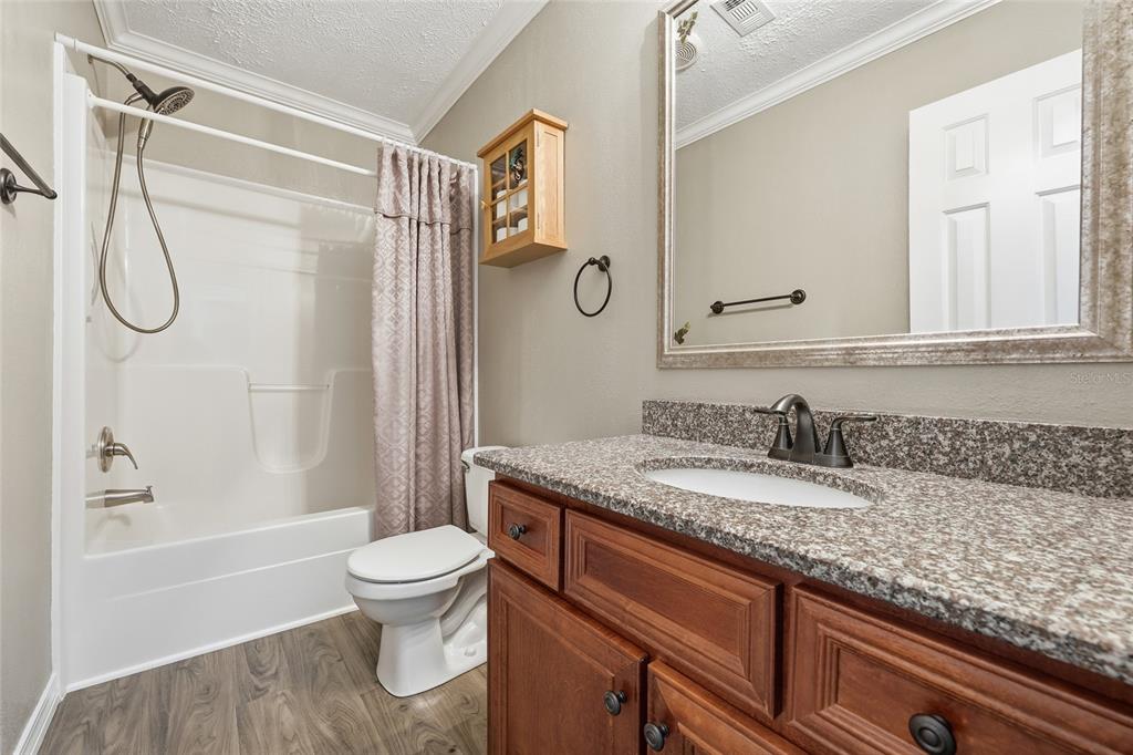 269 Southwest Backwoods Glen Fort White, FL 32038 - Photo 21 of 31 a bathroom with a granite countertop sink toilet and shower