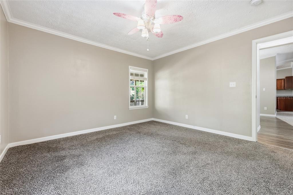 269 Southwest Backwoods Glen Fort White, FL 32038 - Photo 23 of 31 an empty room with windows and chandelier fan