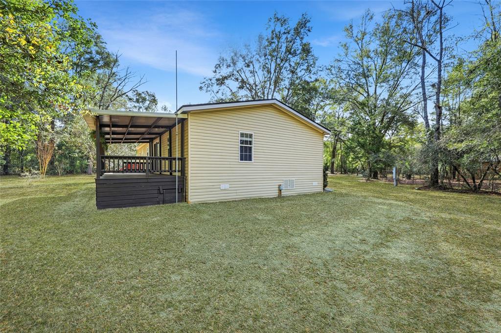 269 Southwest Backwoods Glen Fort White, FL 32038 - Photo 27 of 31 a view of a house with a backyard