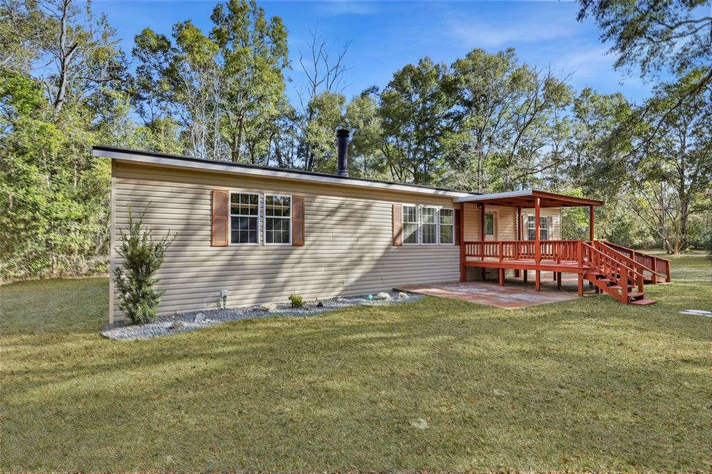 269 Southwest Backwoods Glen Fort White, FL 32038 - Photo 4 of 31 a view of a house with a yard and deck