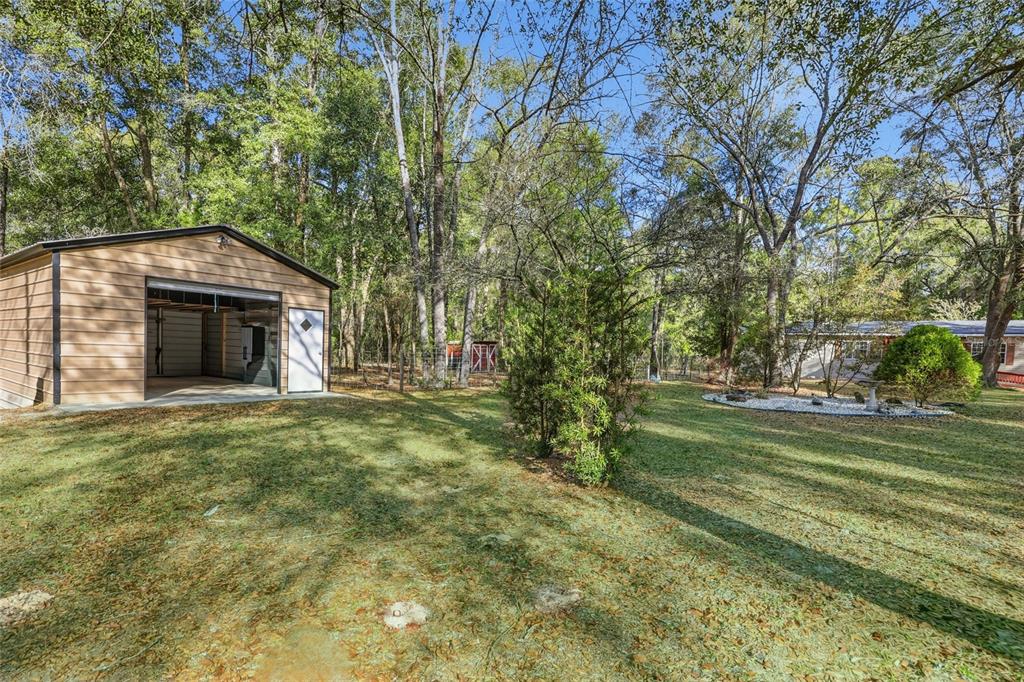 269 Southwest Backwoods Glen Fort White, FL 32038 - Photo 5 of 31 a front view of a house with a garden