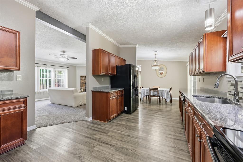 269 Southwest Backwoods Glen Fort White, FL 32038 - Photo 8 of 31 a kitchen with granite countertop a stove a sink and a refrigerator