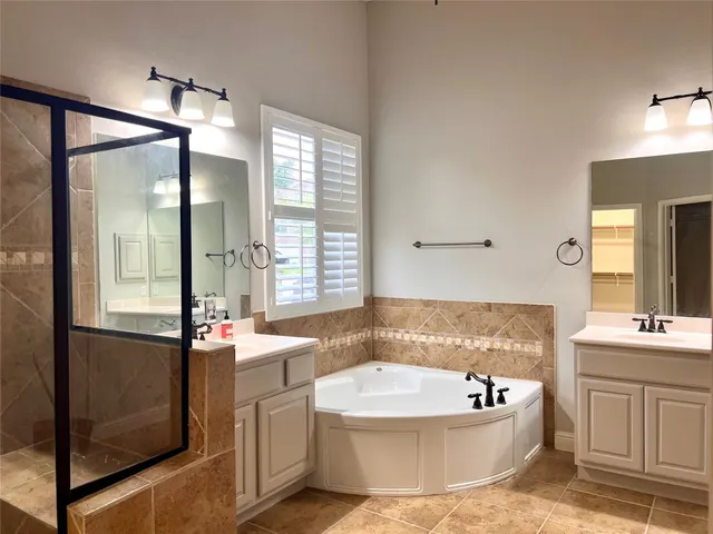 a bathroom with a sink shower and a mirror