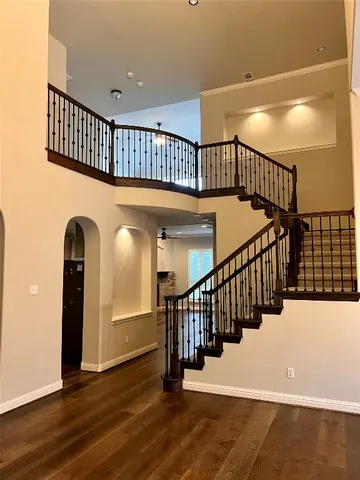 a view of entryway with wooden floor and stairs