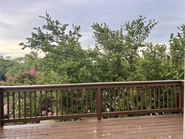 a balcony with wooden floor and fence