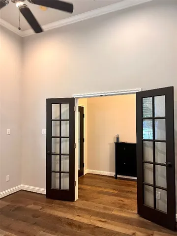 a view of a hallway with wooden floor and stairs