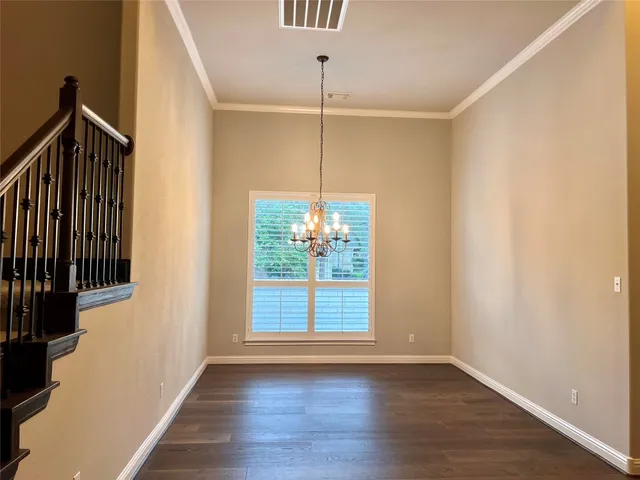 a view of an empty room with a fireplace and a window