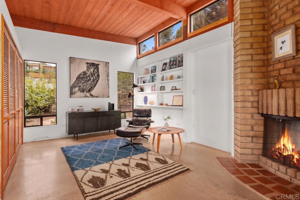 3533 Dove Hollow Road Encinitas, CA 92024 - Photo 13 of 32 a living room with furniture and a fireplace