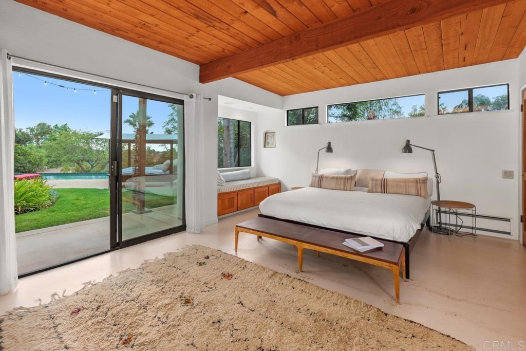3533 Dove Hollow Road Encinitas, CA 92024 - Photo 15 of 32 a bedroom with furniture and large windows
