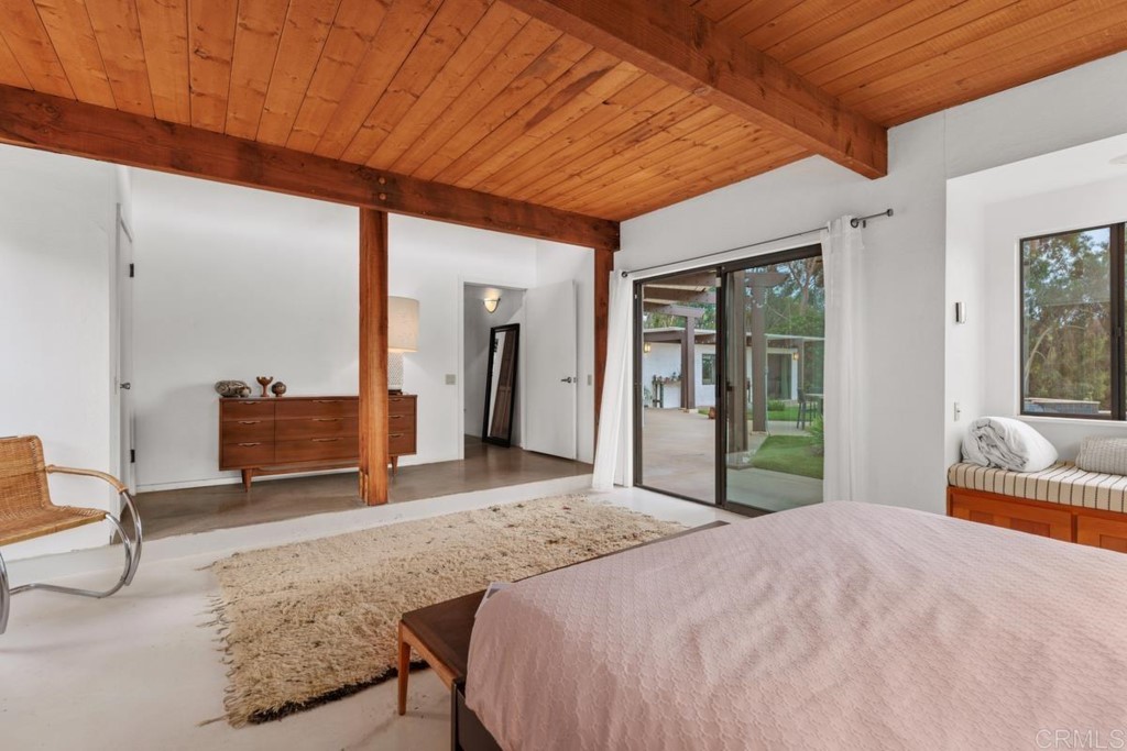 3533 Dove Hollow Road Encinitas, CA 92024 - Photo 16 of 32 a bedroom with a bed and large windows