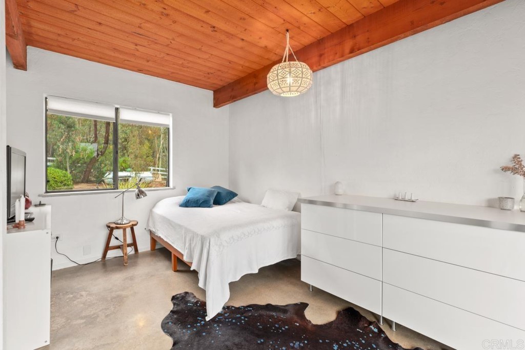 3533 Dove Hollow Road Encinitas, CA 92024 - Photo 19 of 32 a living room with a bed furniture and a large window