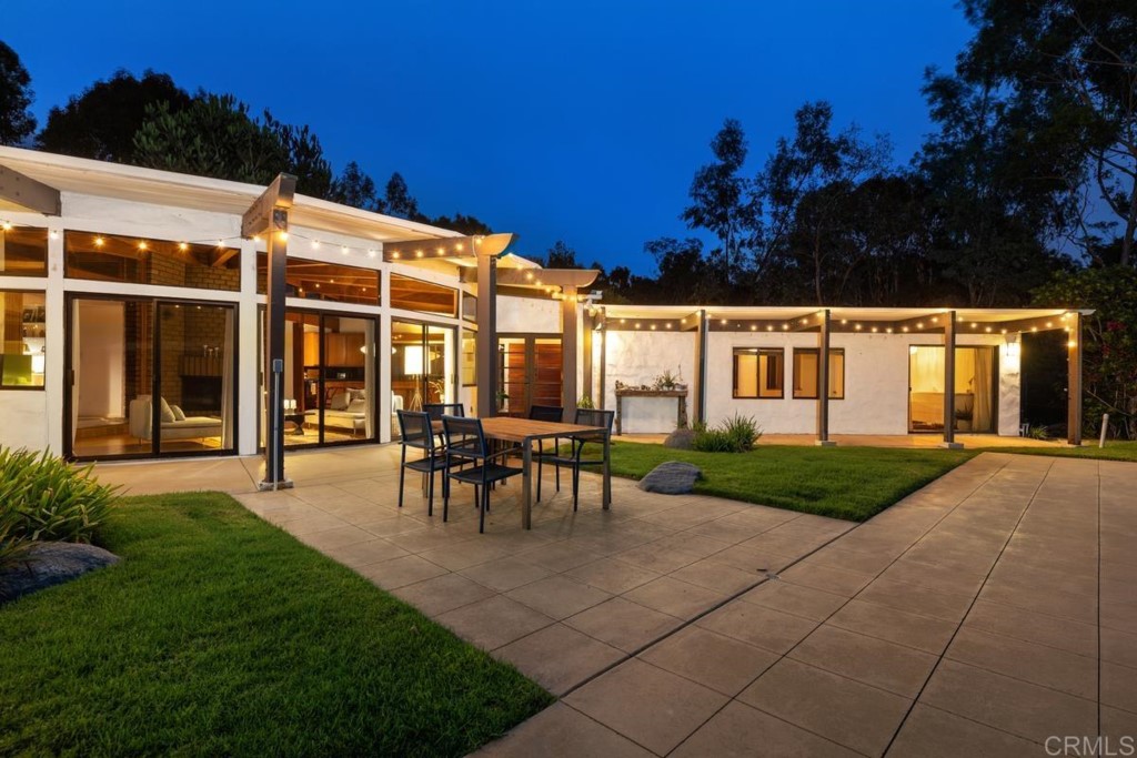 3533 Dove Hollow Road Encinitas, CA 92024 - Photo 3 of 32 a view of a patio with table and chairs and potted plants