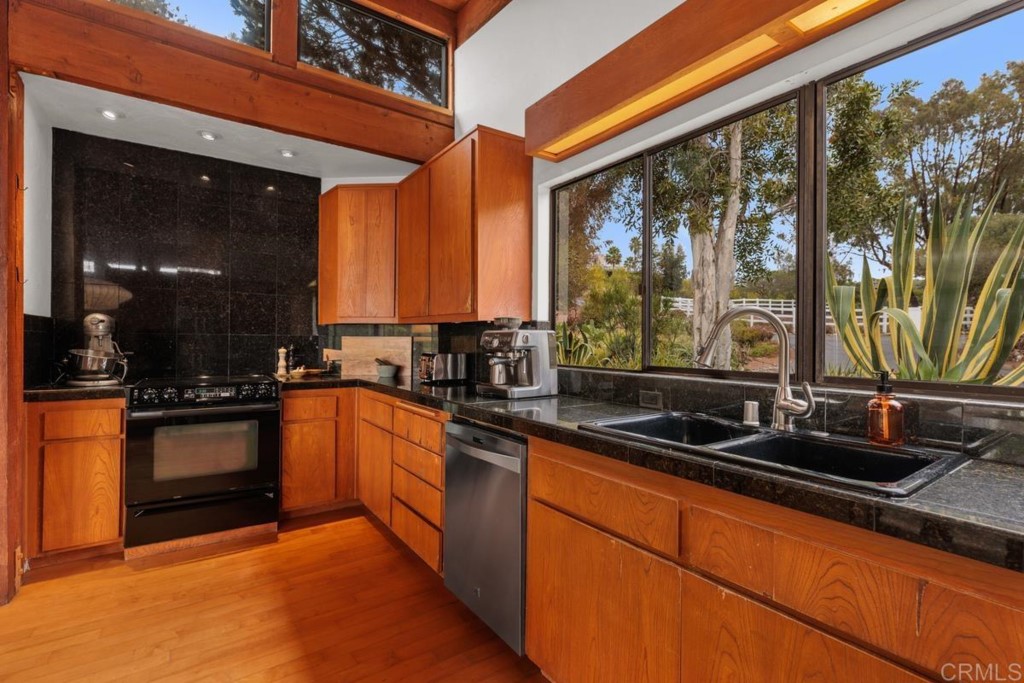 3533 Dove Hollow Road Encinitas, CA 92024 - Photo 10 of 32 a kitchen with stainless steel appliances a sink stove and cabinets