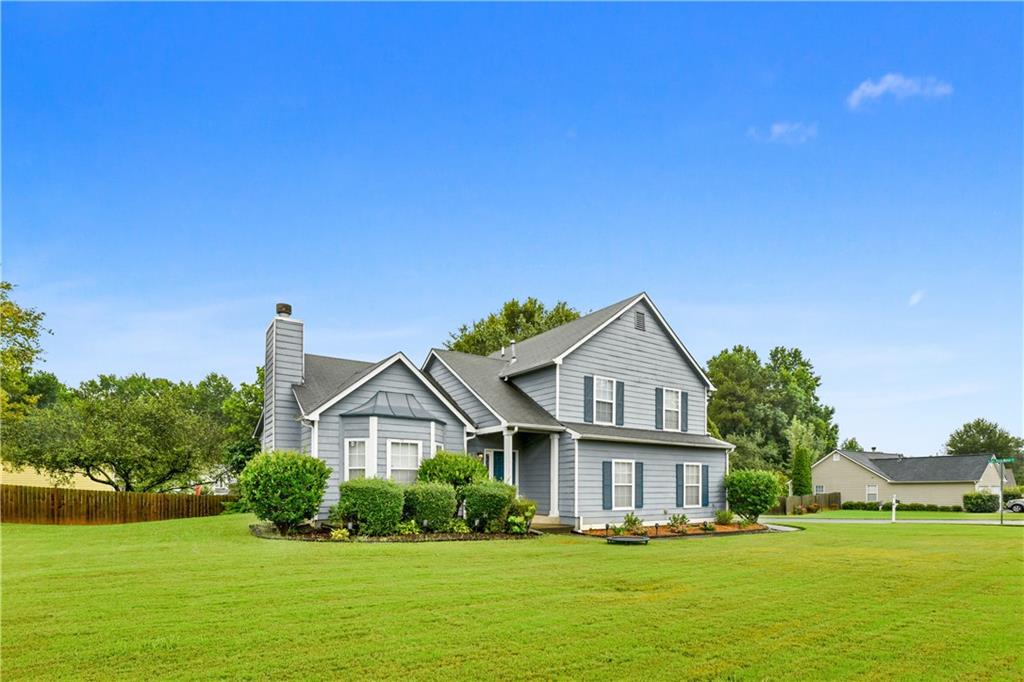 2729 Lake Park Ridge West Acworth, GA 30101 - Photo 1 of 1 a front view of a house with garden and trees