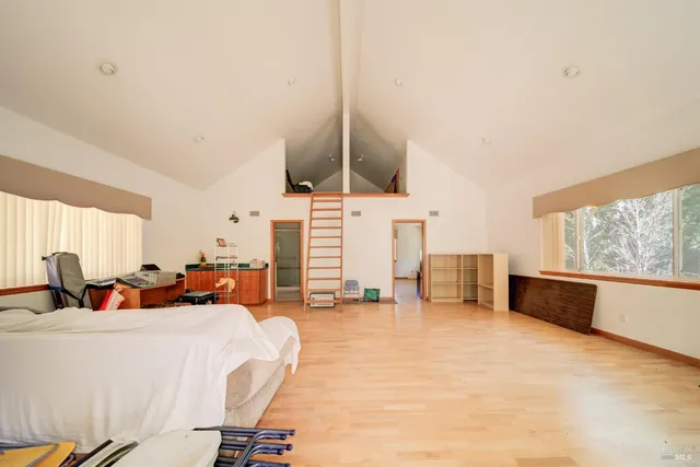 a bed room with two bed and a large window