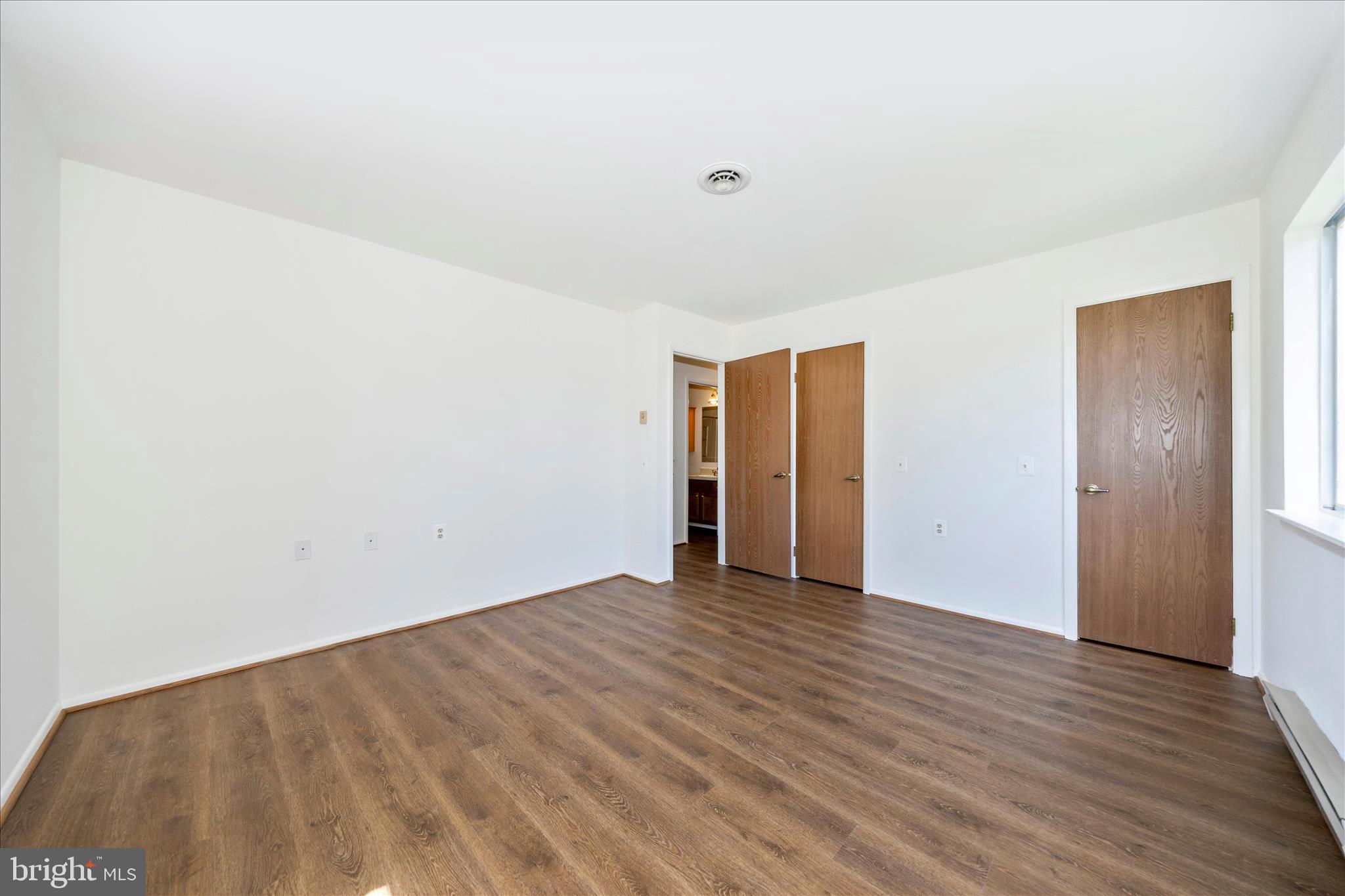 5738 Box Elder Court Frederick, MD 21703 - Photo 21 of 50 a view of an empty room with wooden floor and closet