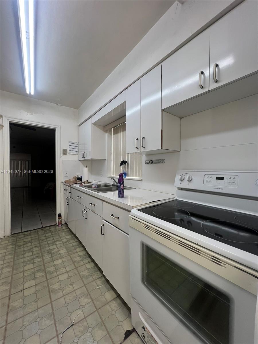 5561 Southwest 5th Terrace Miami, FL 33134 - Photo 26 of 39 a kitchen with a stove cabinets and counter space
