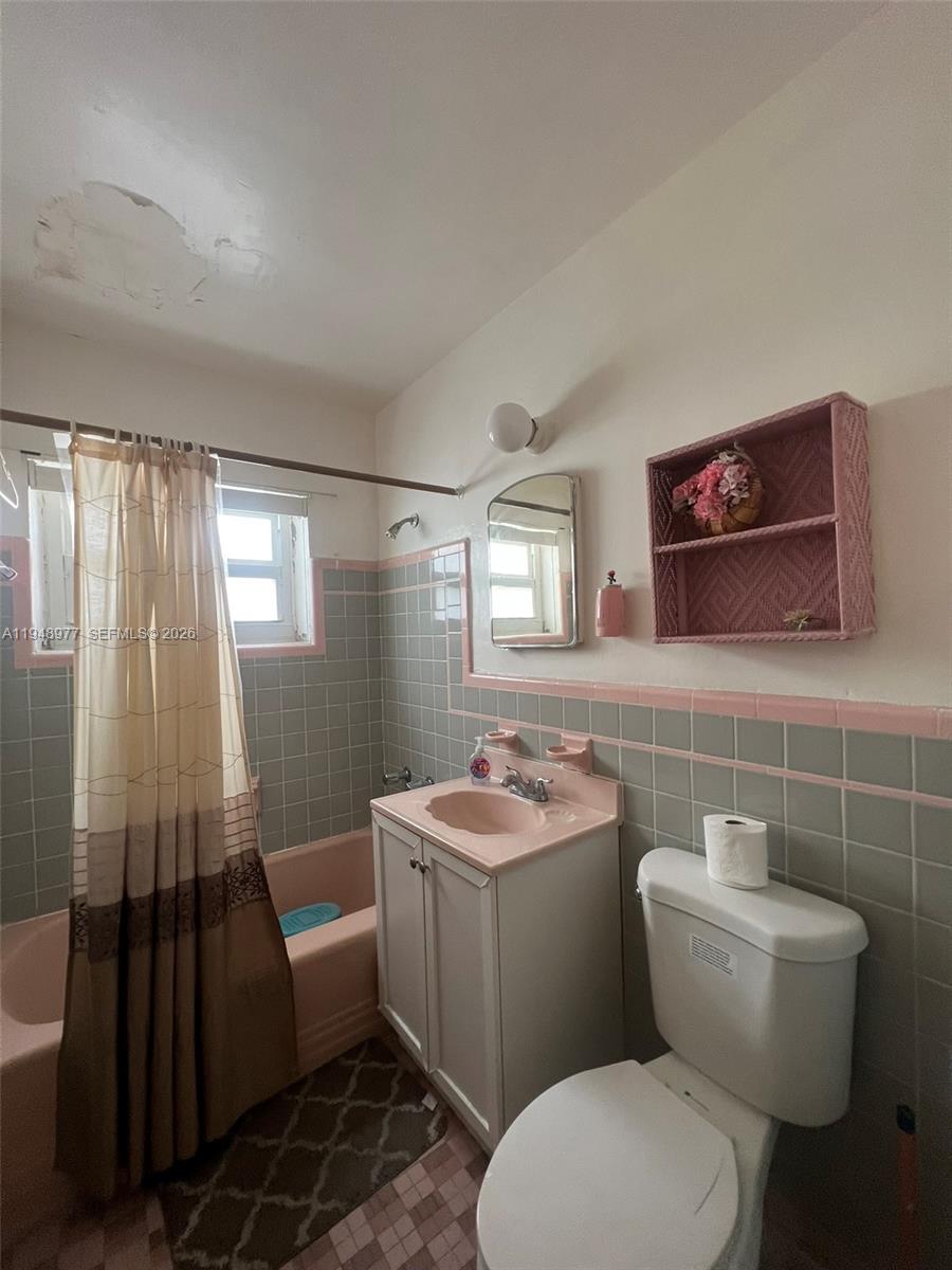 5561 Southwest 5th Terrace Miami, FL 33134 - Photo 36 of 39 a bathroom with a toilet sink and mirror