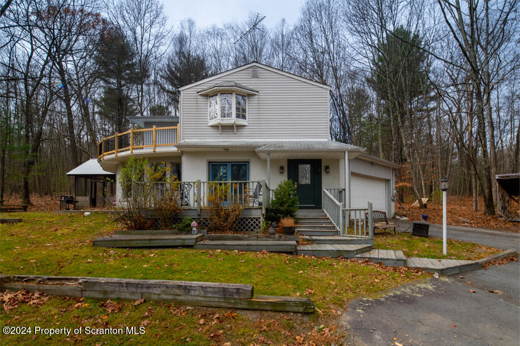 106 Rim Rock Road Milford, PA 18337 - Photo 2 of 32 a front view of a house with garden