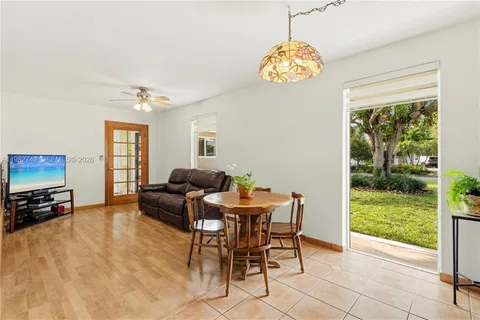 a living room with furniture a chandelier and a floor to ceiling window