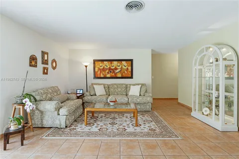 a living room with furniture and a painting